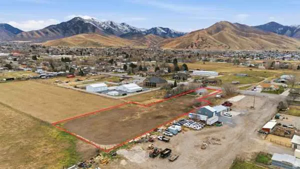 Aerial overview of property's location with property parcel outlined and mountains