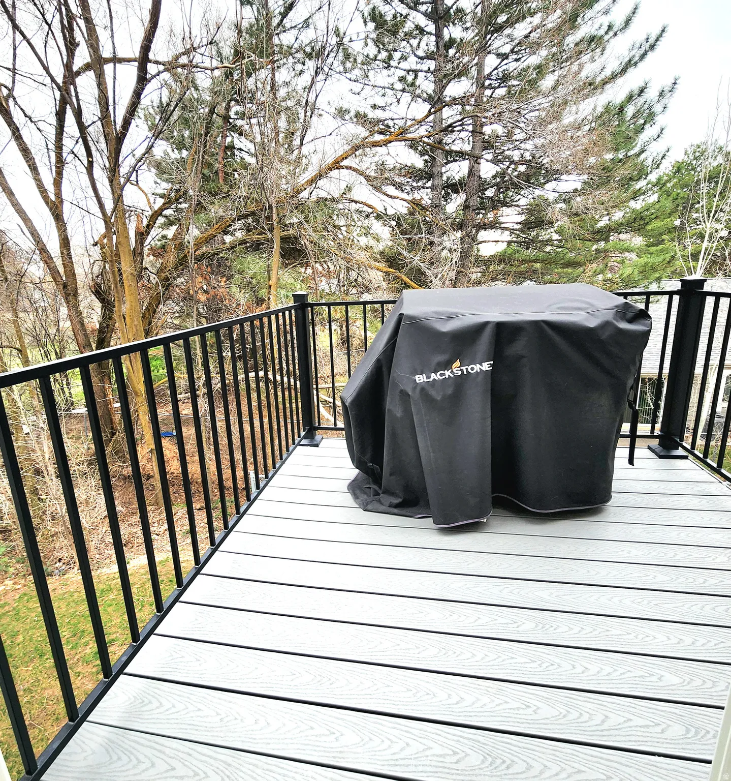 Wooden deck featuring a grill