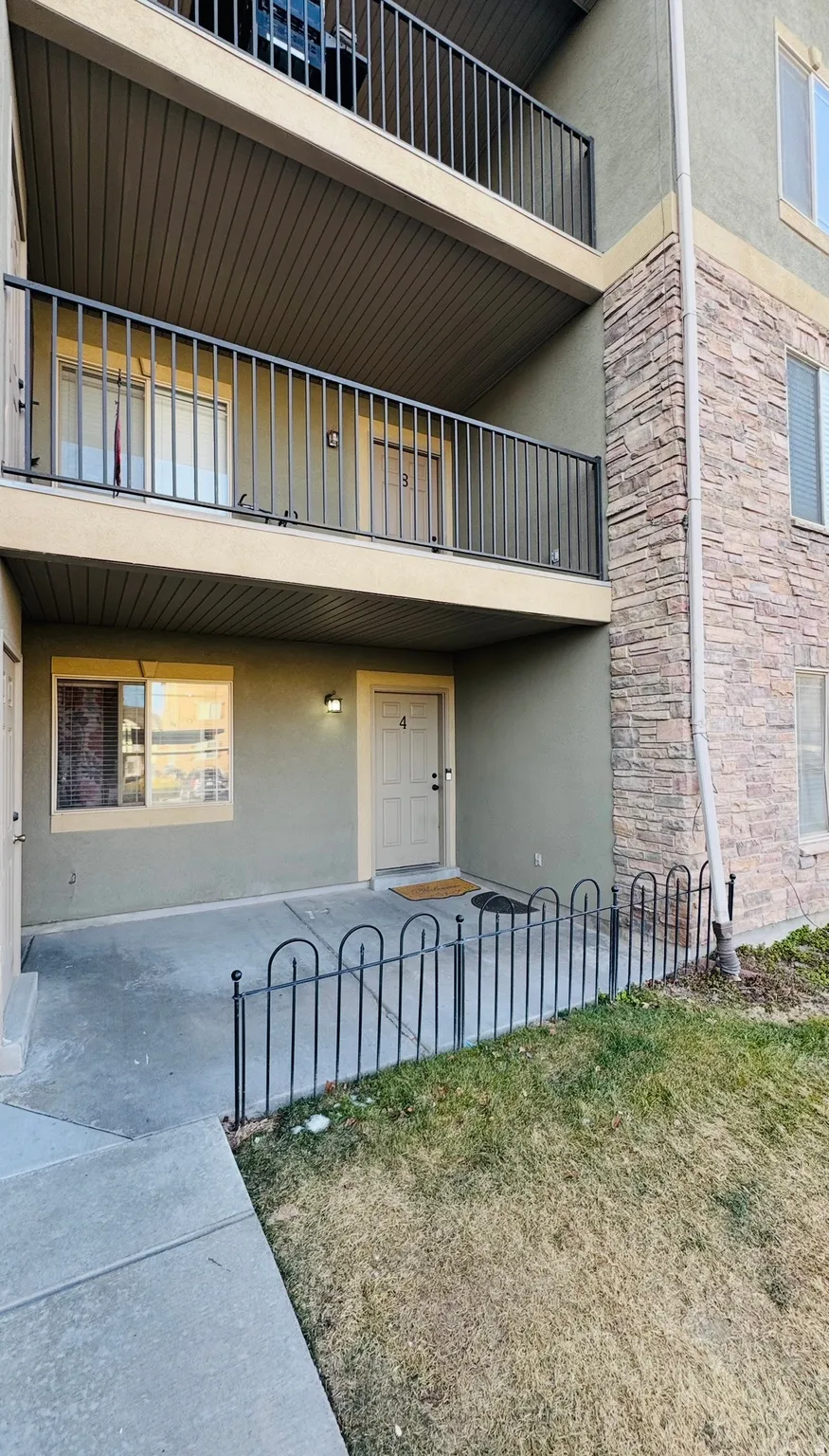 Doorway to property with stucco siding and stone siding