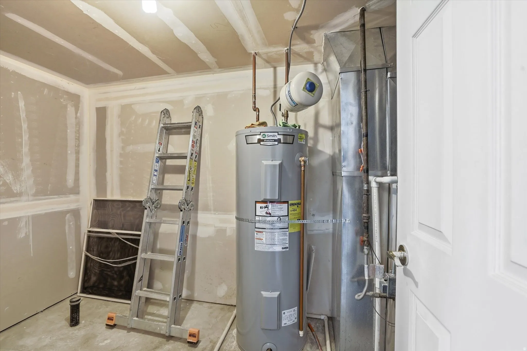 Utilities room with plumbing for an additional bathroom