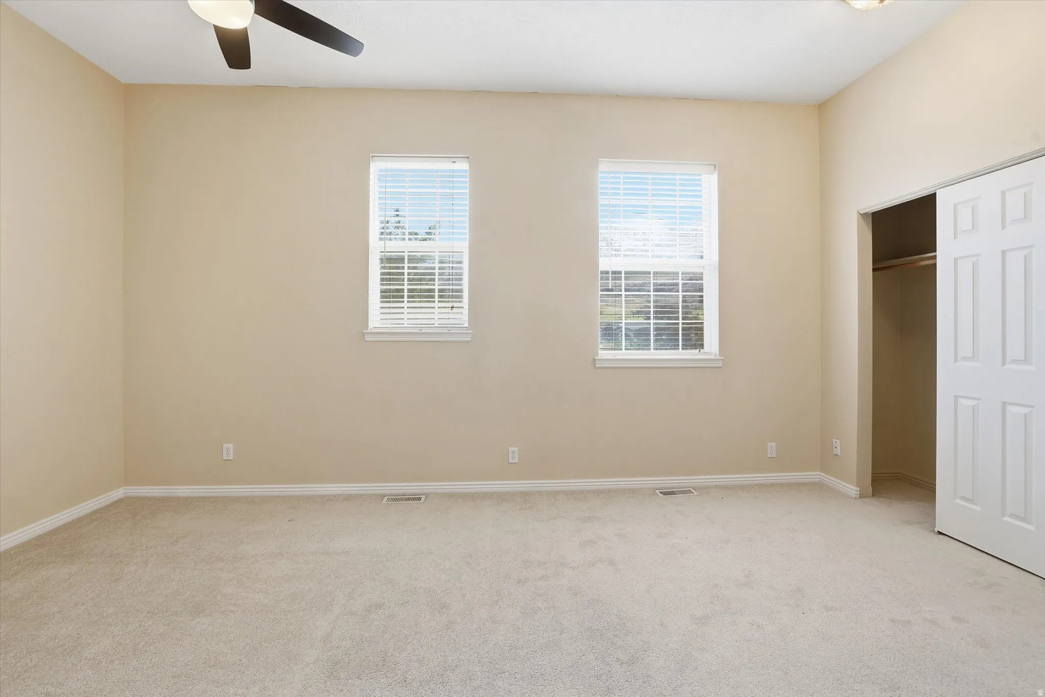 Bedroom with windows facing the golf course and mountains
