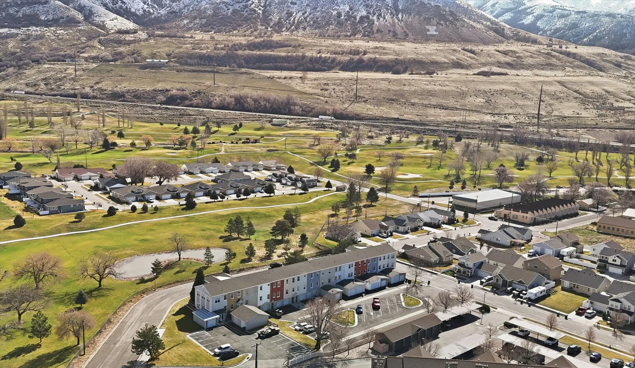 Bird's eye view of a mountain backdrop and a golf club