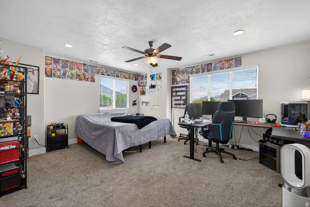 Bedroom featuring light carpet, a desk, a ceiling fan, recessed lighting, and a textured ceiling