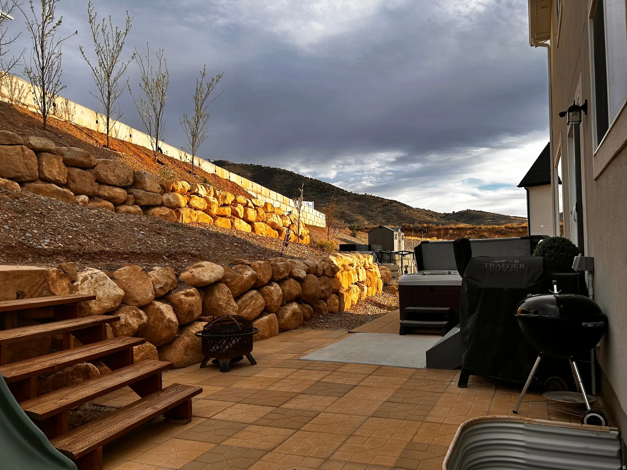 View of patio / terrace with a mountain view, grilling area, and a fire pit