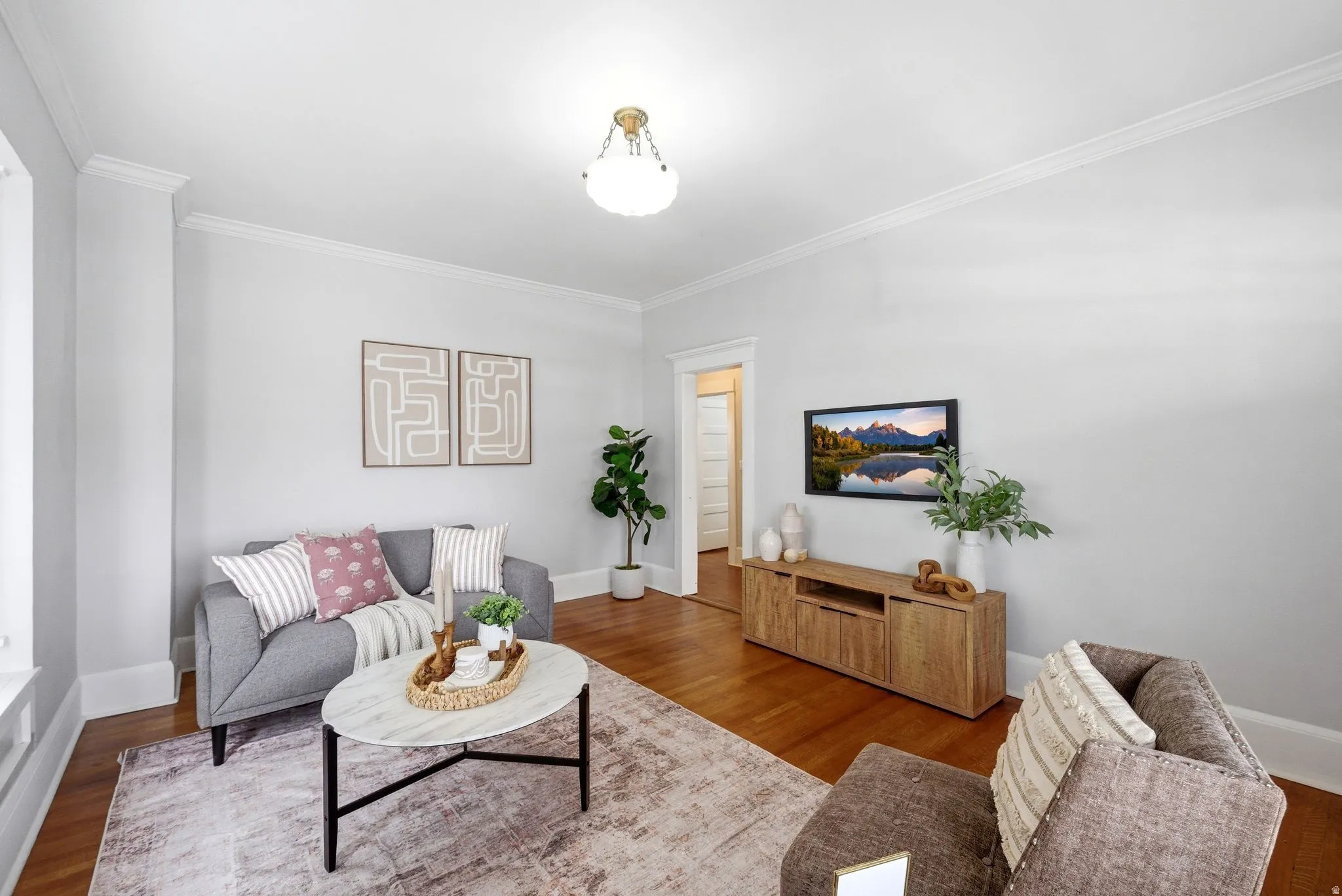 Living room featuring crown molding and wood finished floors