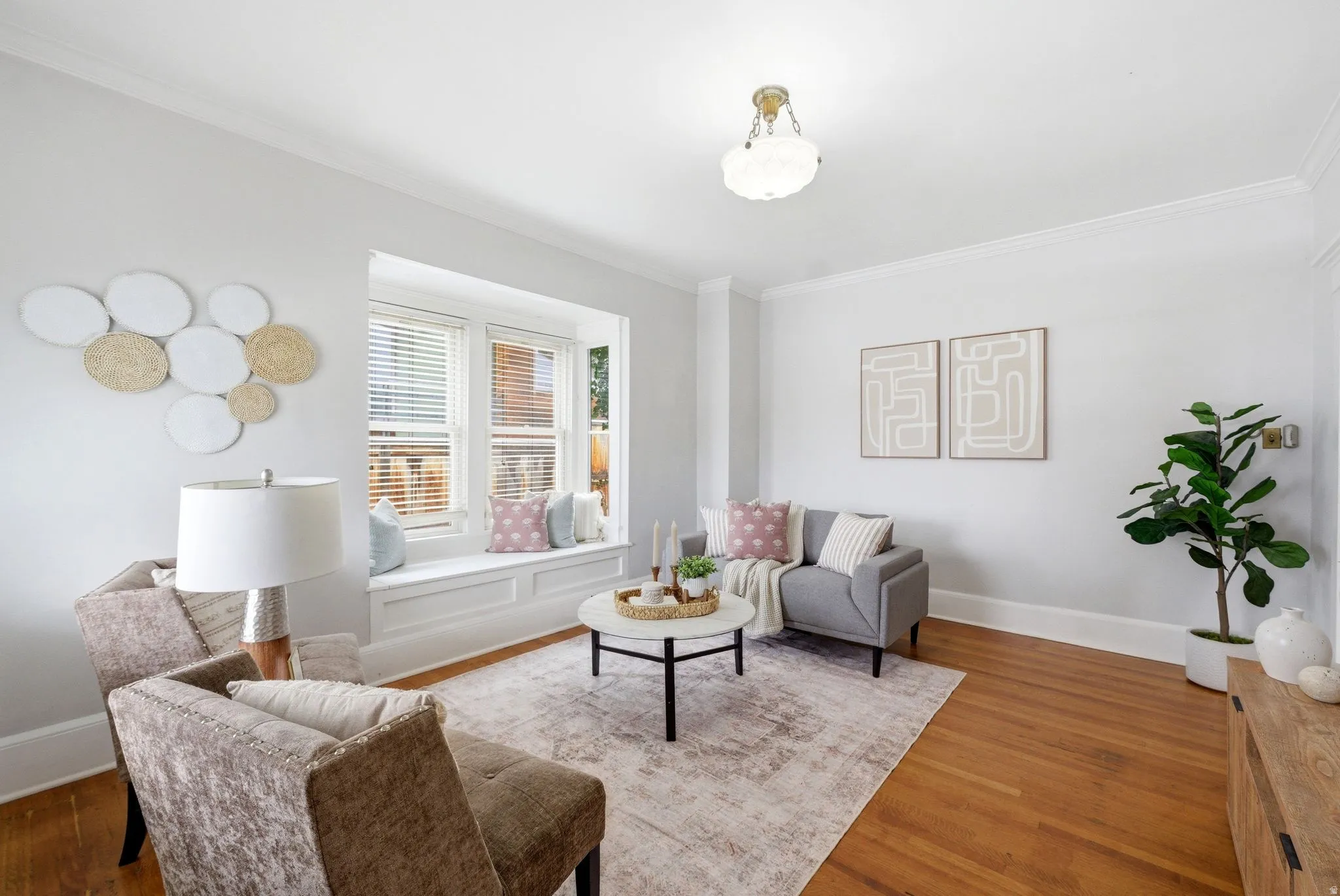 Living room featuring wood finished floors and crown molding