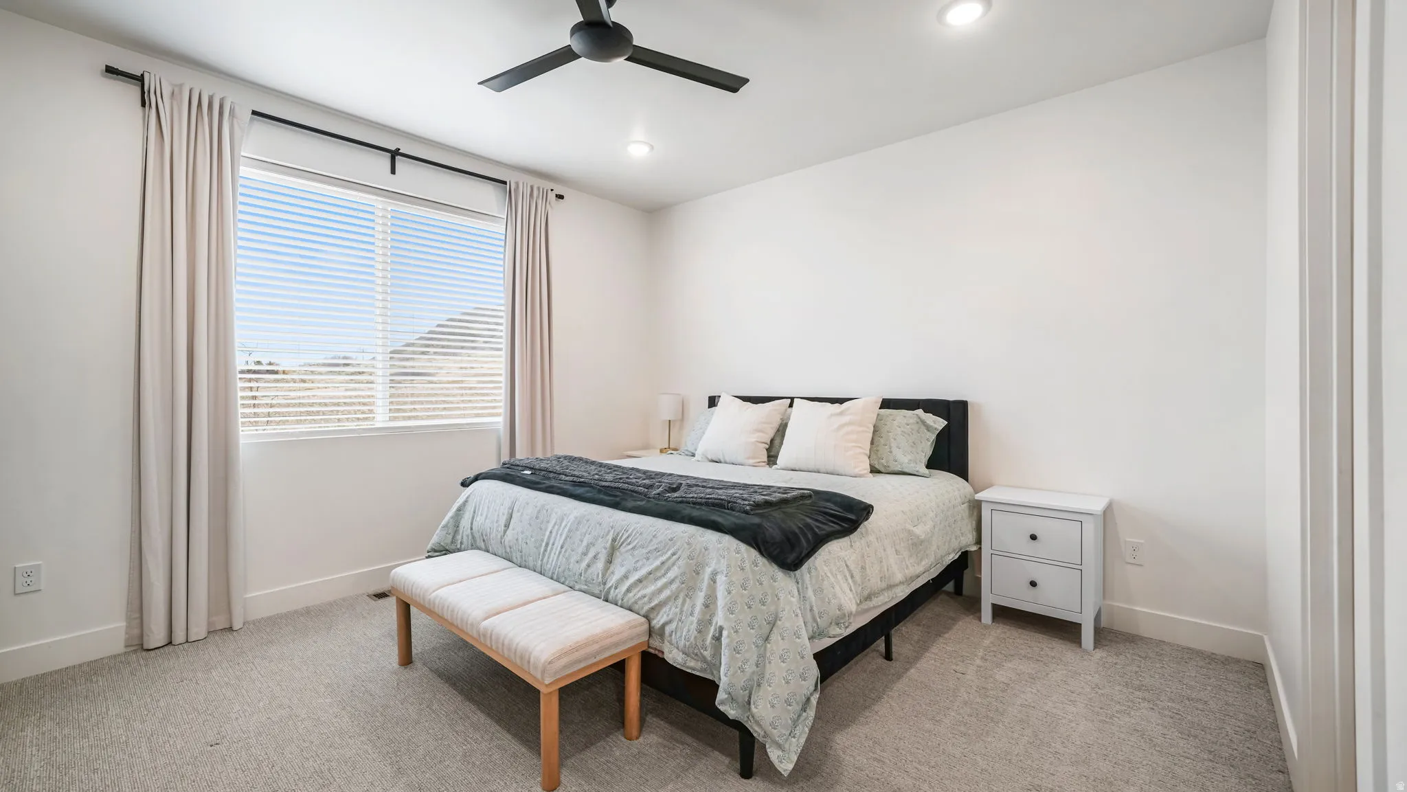 Bedroom with a ceiling fan, light carpet, and recessed lighting