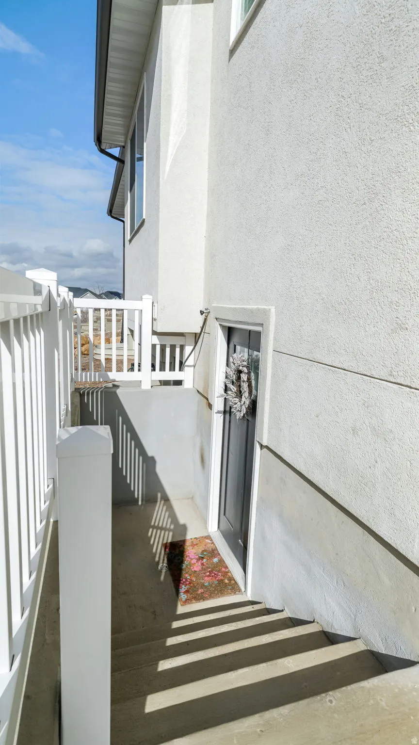 View of exterior entry featuring stucco siding