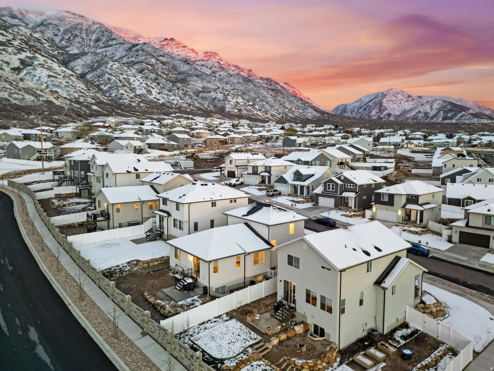 Snowy aerial view with a mountain view and a residential view