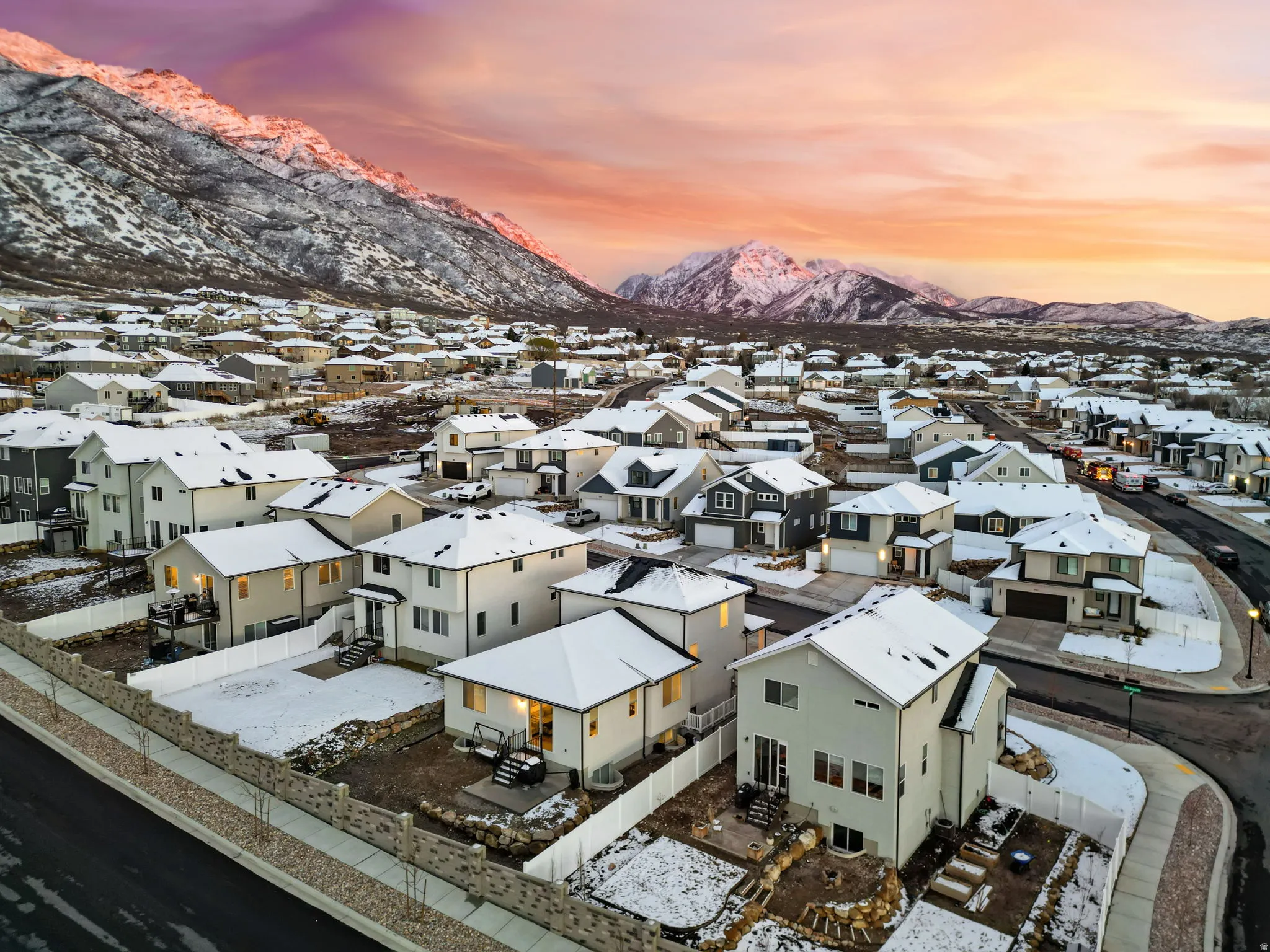 Snowy aerial view featuring a mountain view and a residential view