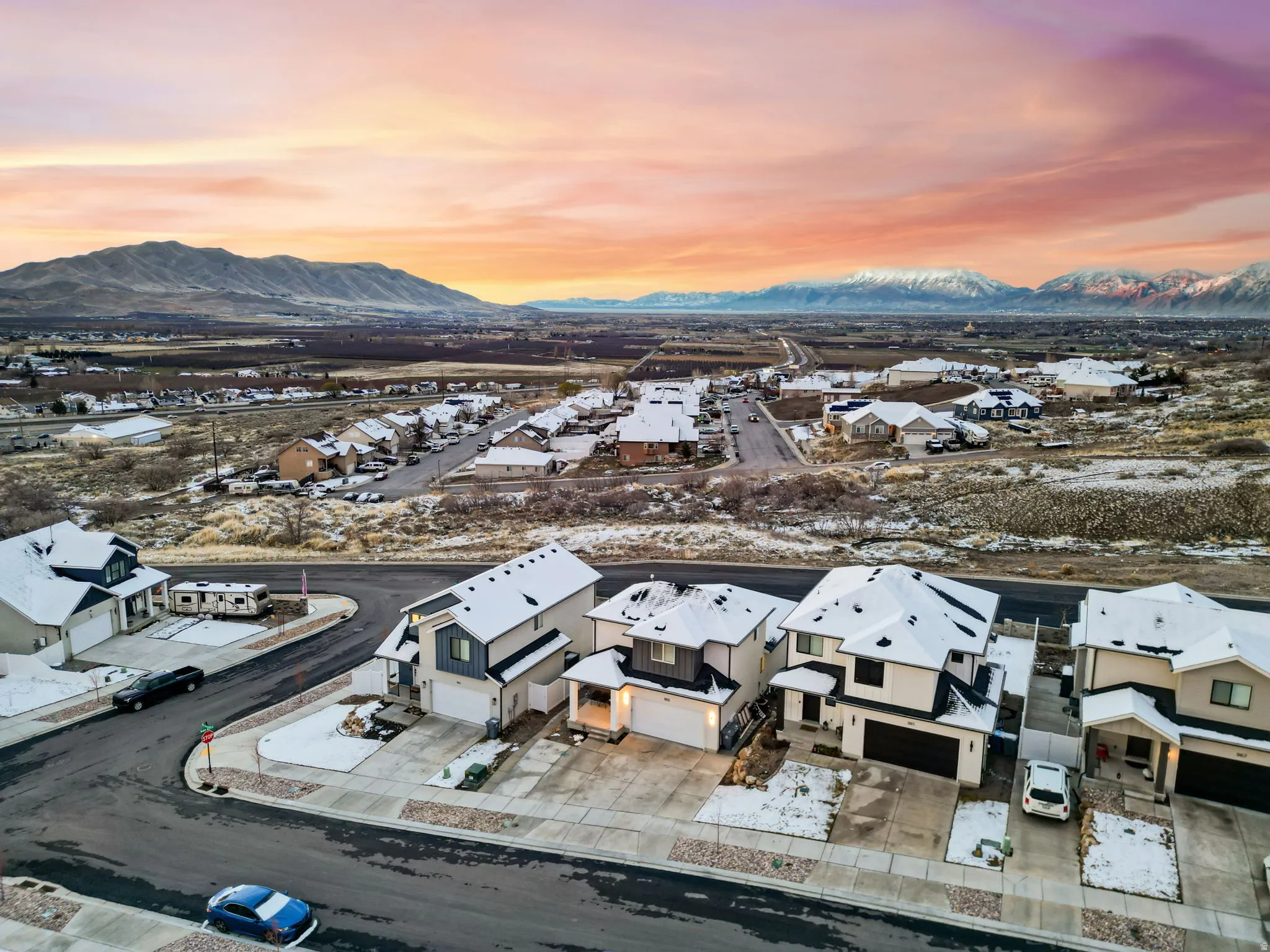 Snowy aerial view featuring a residential view and a mountain view