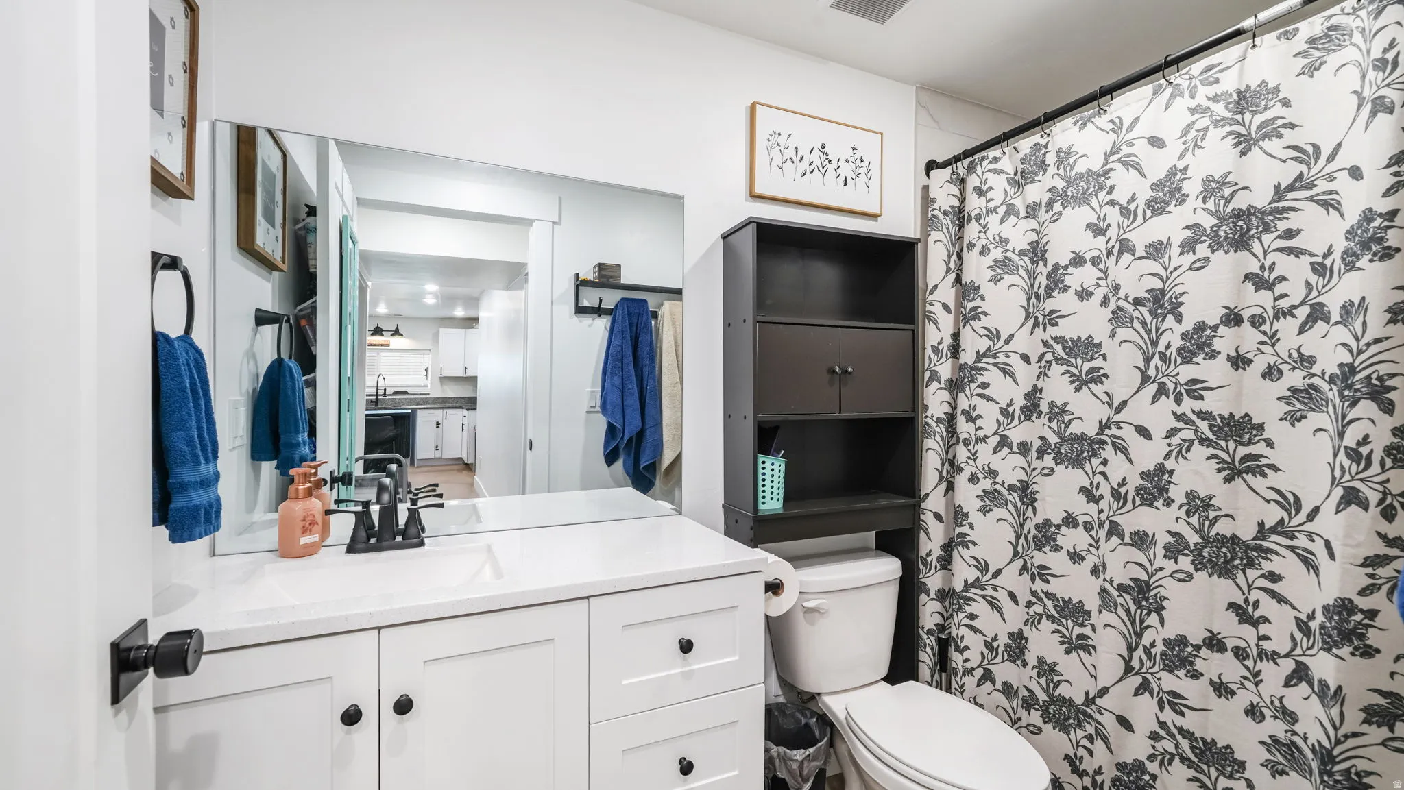 Full bathroom with vanity and a shower with shower curtain