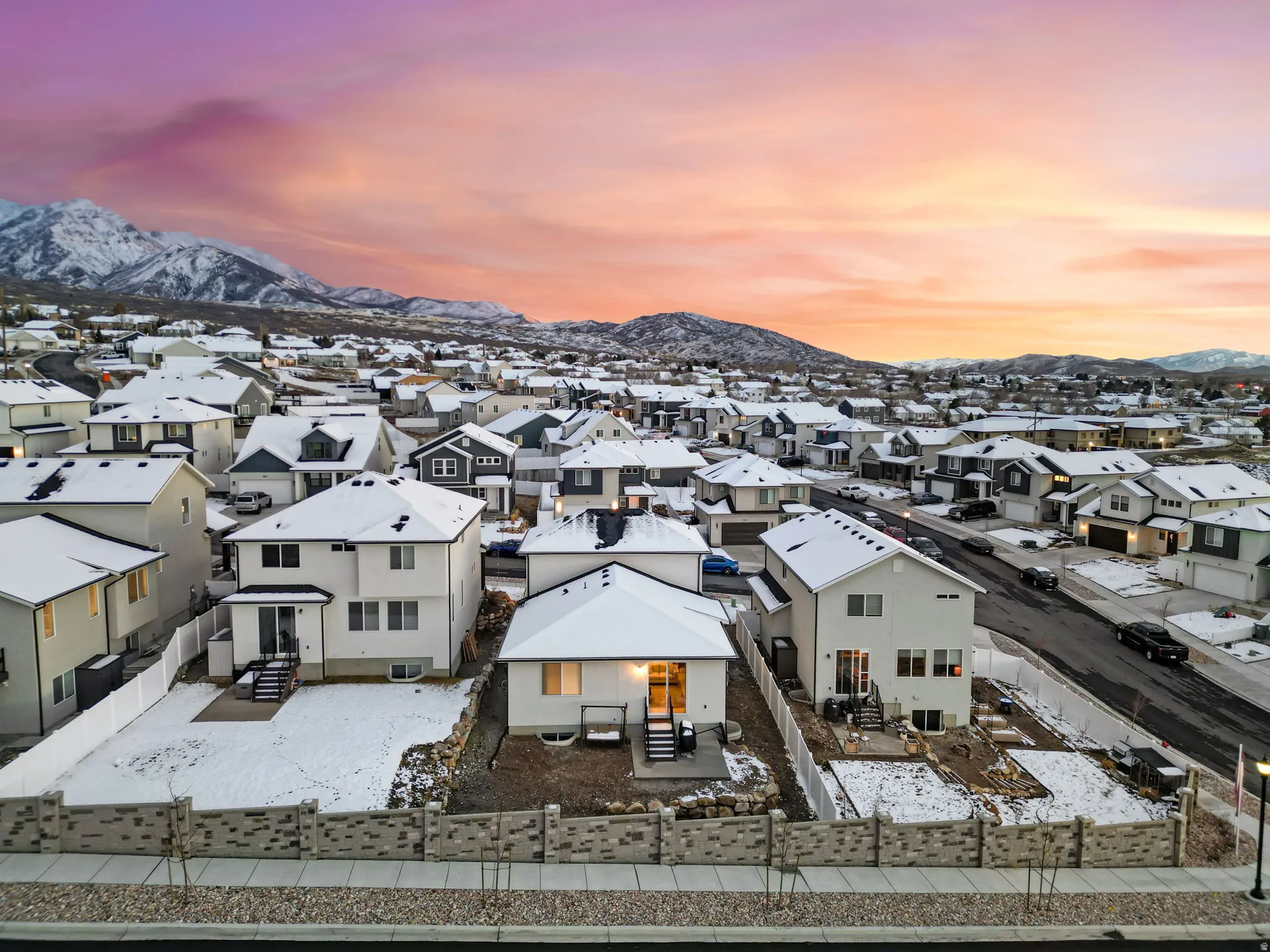 Snowy aerial view with a mountain view and a residential view
