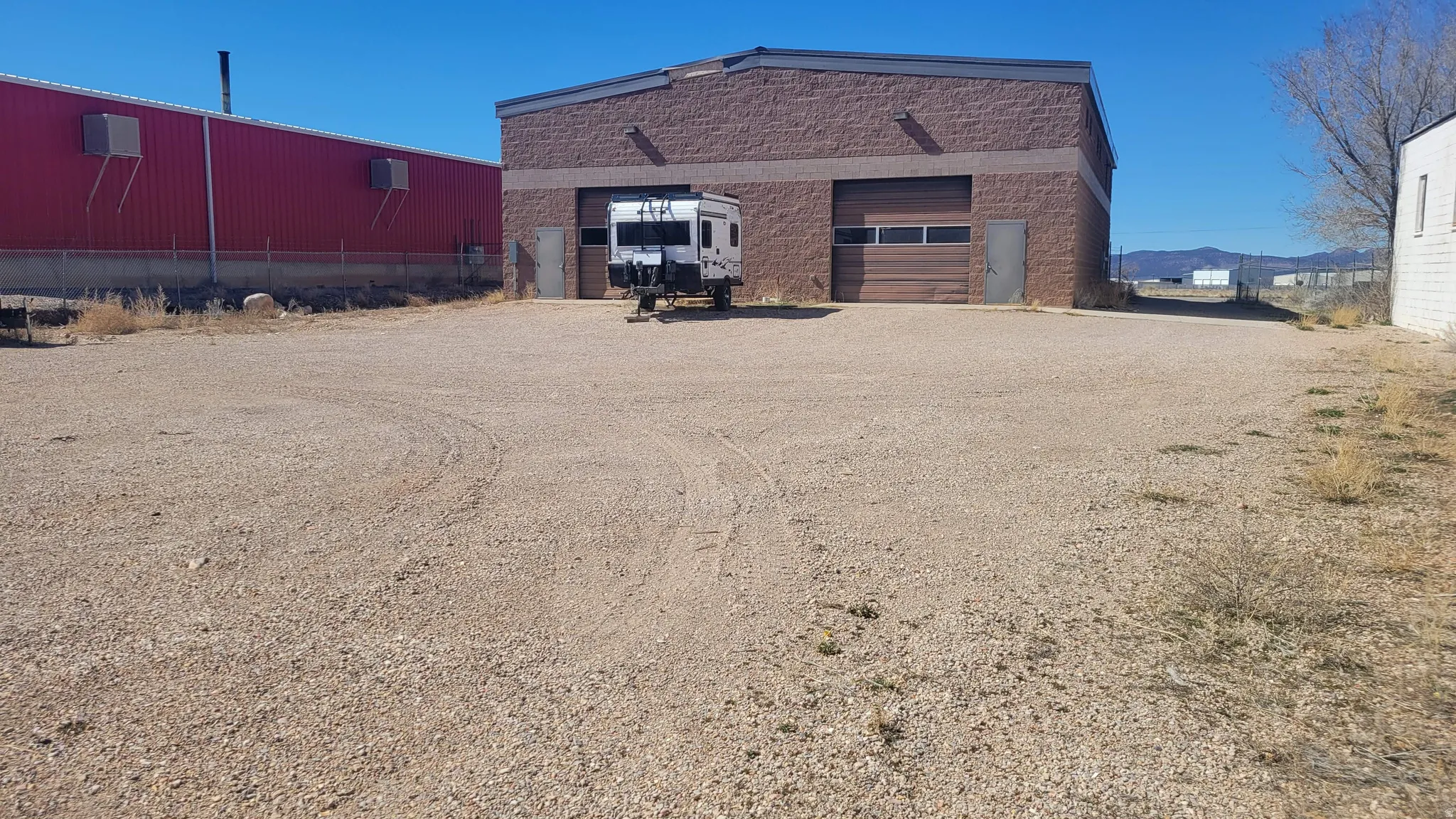 View of home's exterior with a garage, driveway, and brick siding