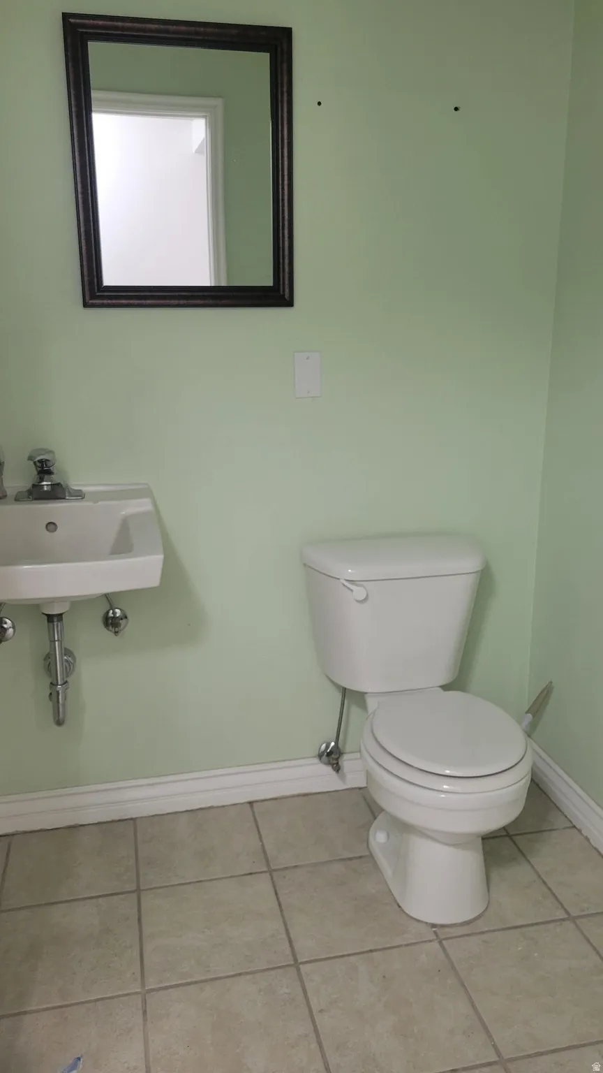 Bathroom with light tile patterned flooring