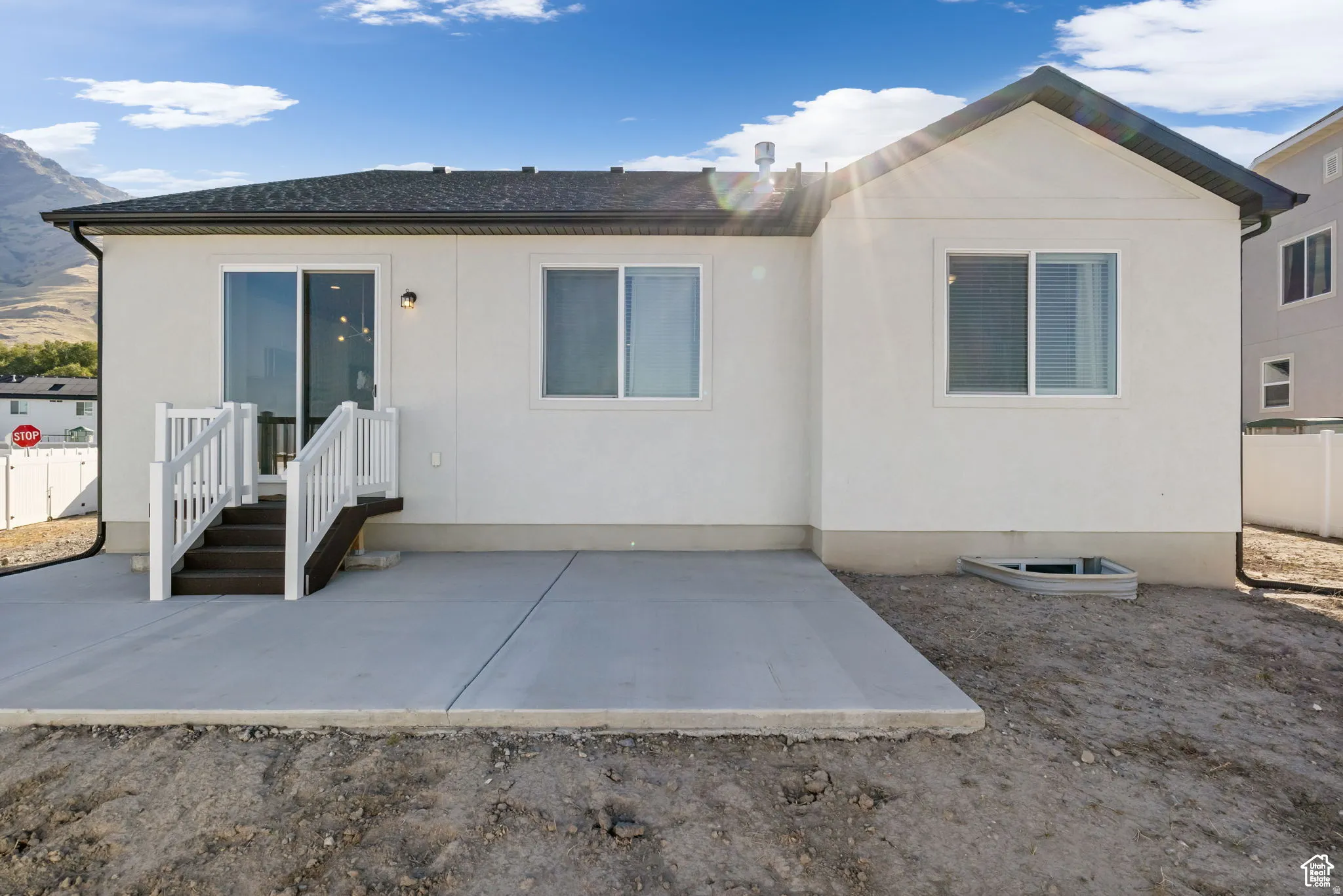 Back of property with a patio area and stucco siding