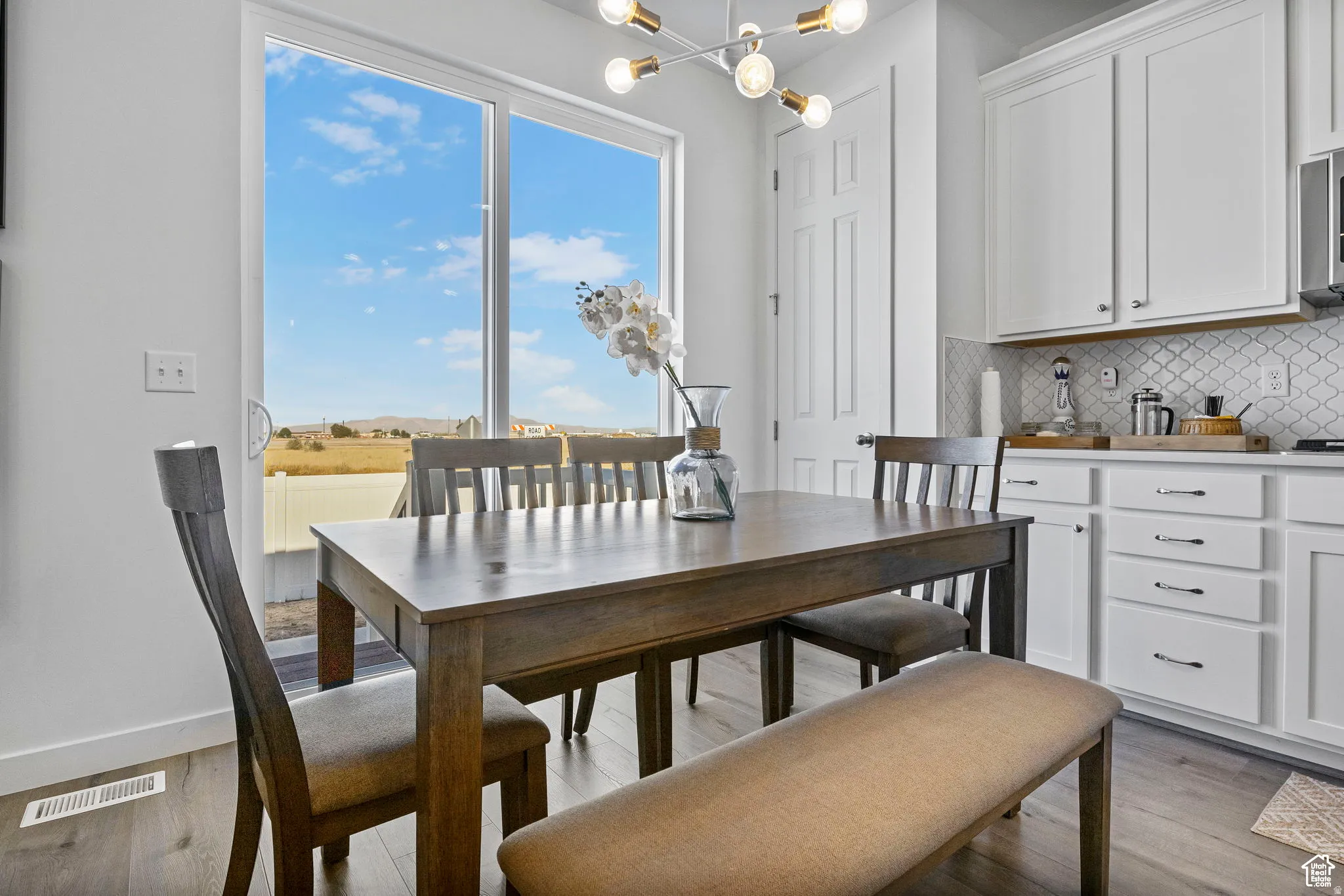 Dining room featuring suspended lighting and dark wood-type flooring
