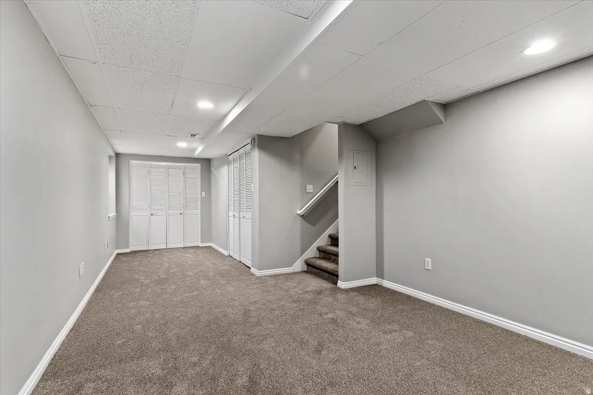 Finished basement featuring carpet floors, a paneled ceiling, and recessed lighting