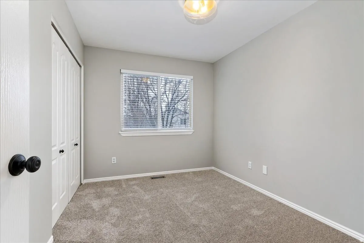 Unfurnished bedroom featuring carpet flooring and a closet