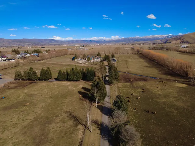 Aerial view of sparsely populated area with mountains and extensive farmland