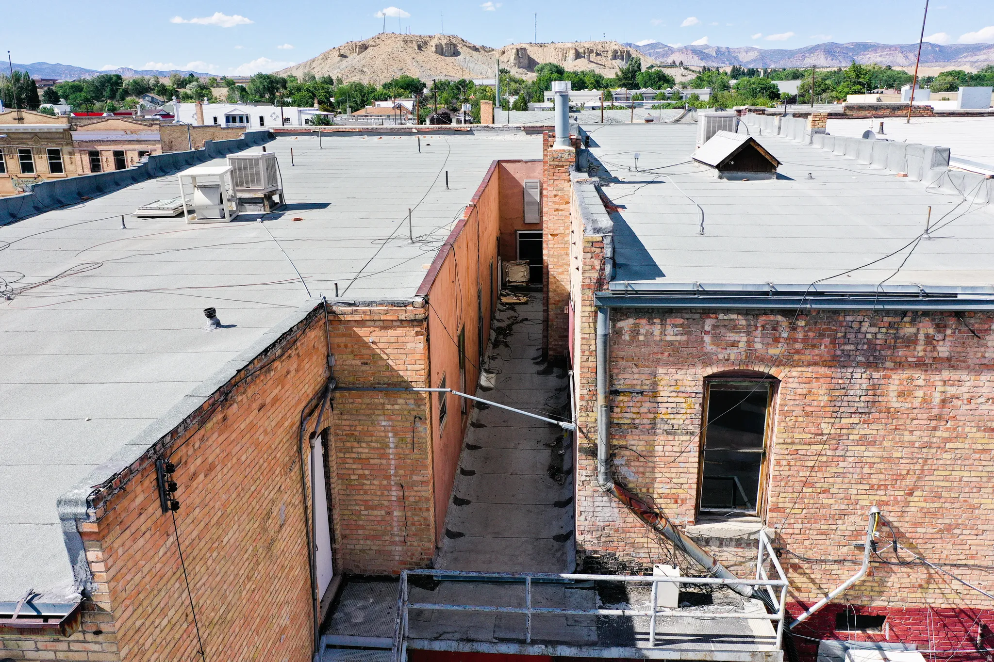 View of property exterior with a mountain view and brick siding