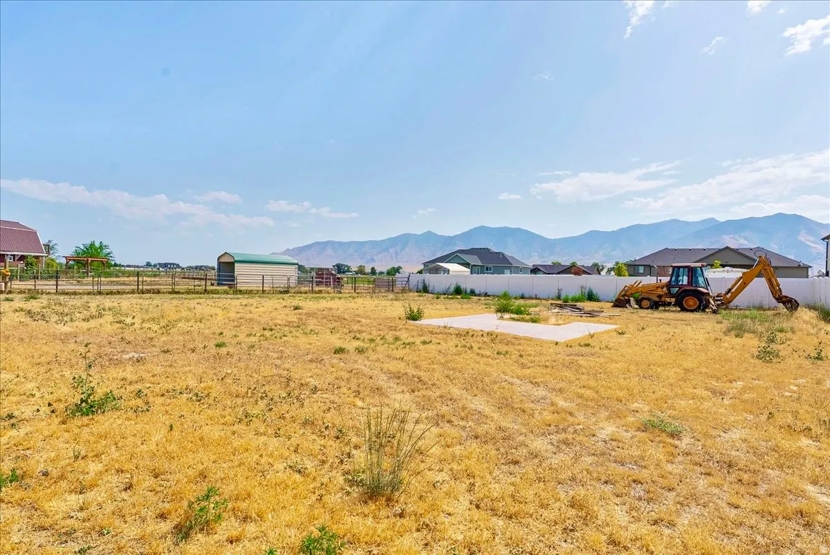 View of unfinished yard featuring a mountain view and a patio area