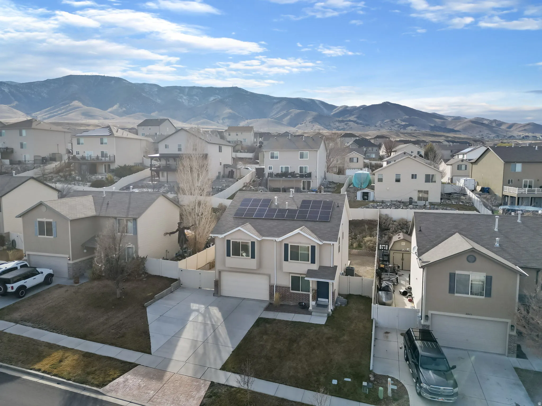 Aerial view of residential area featuring a mountainous background
