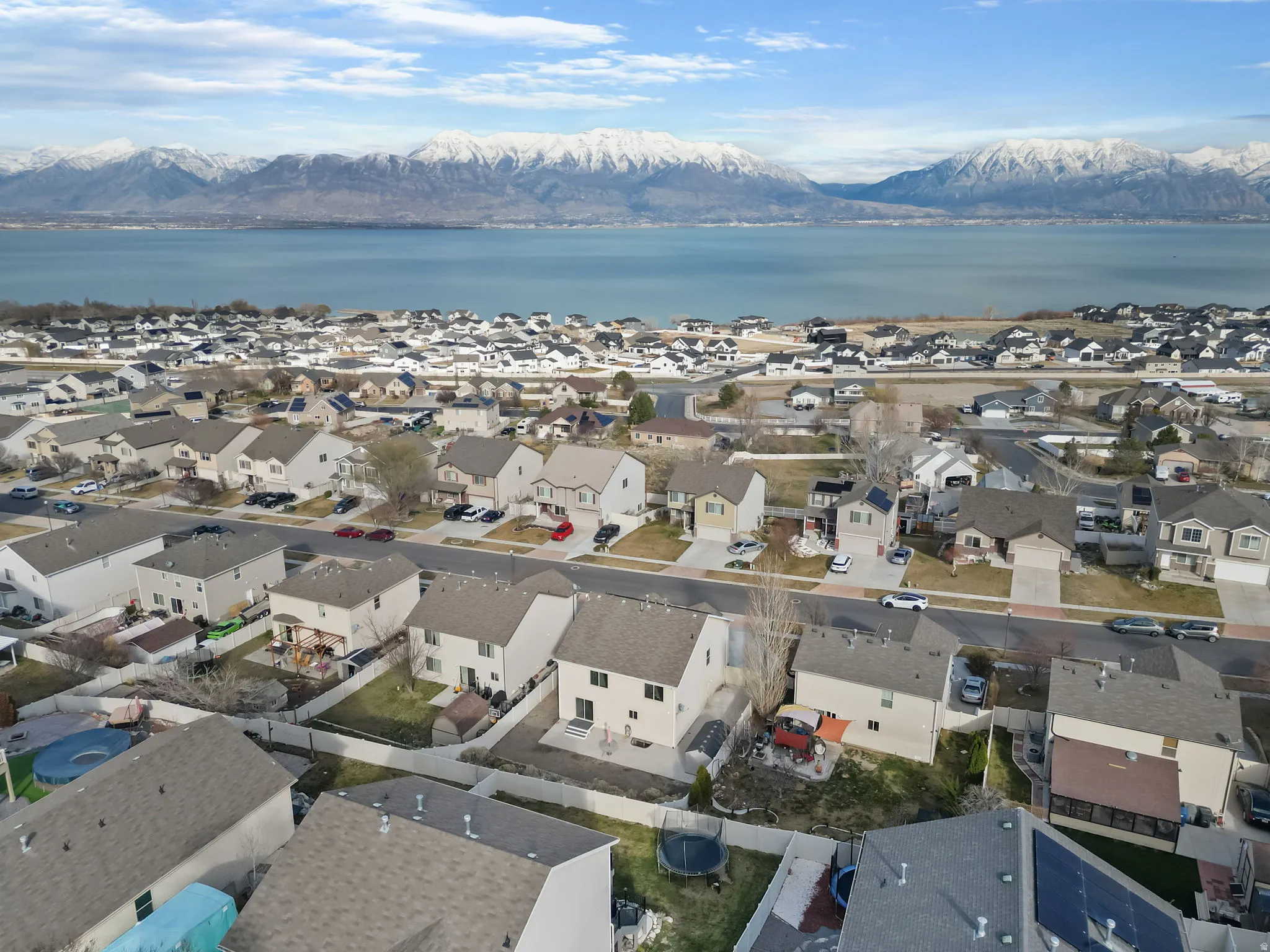 Aerial overview of property's location with nearby suburban area and a water and mountain view