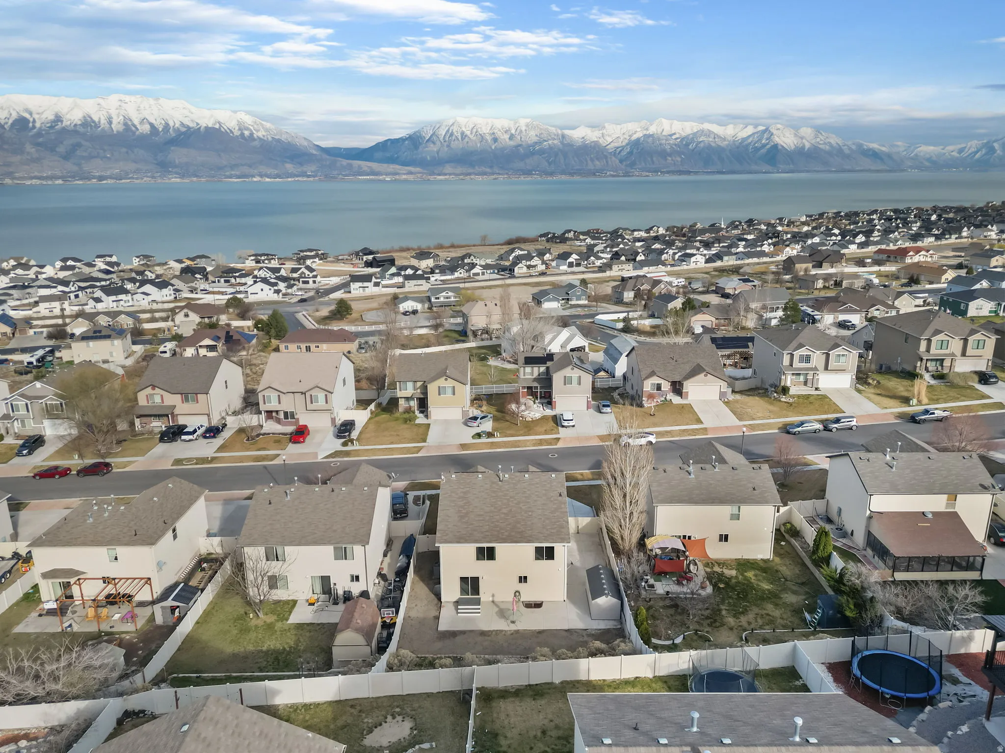 Aerial view of property and surrounding area with nearby suburban area and a water and mountain view