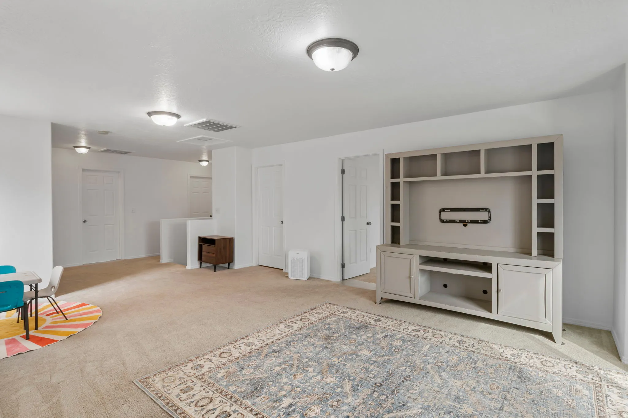 Unfurnished room featuring light carpet