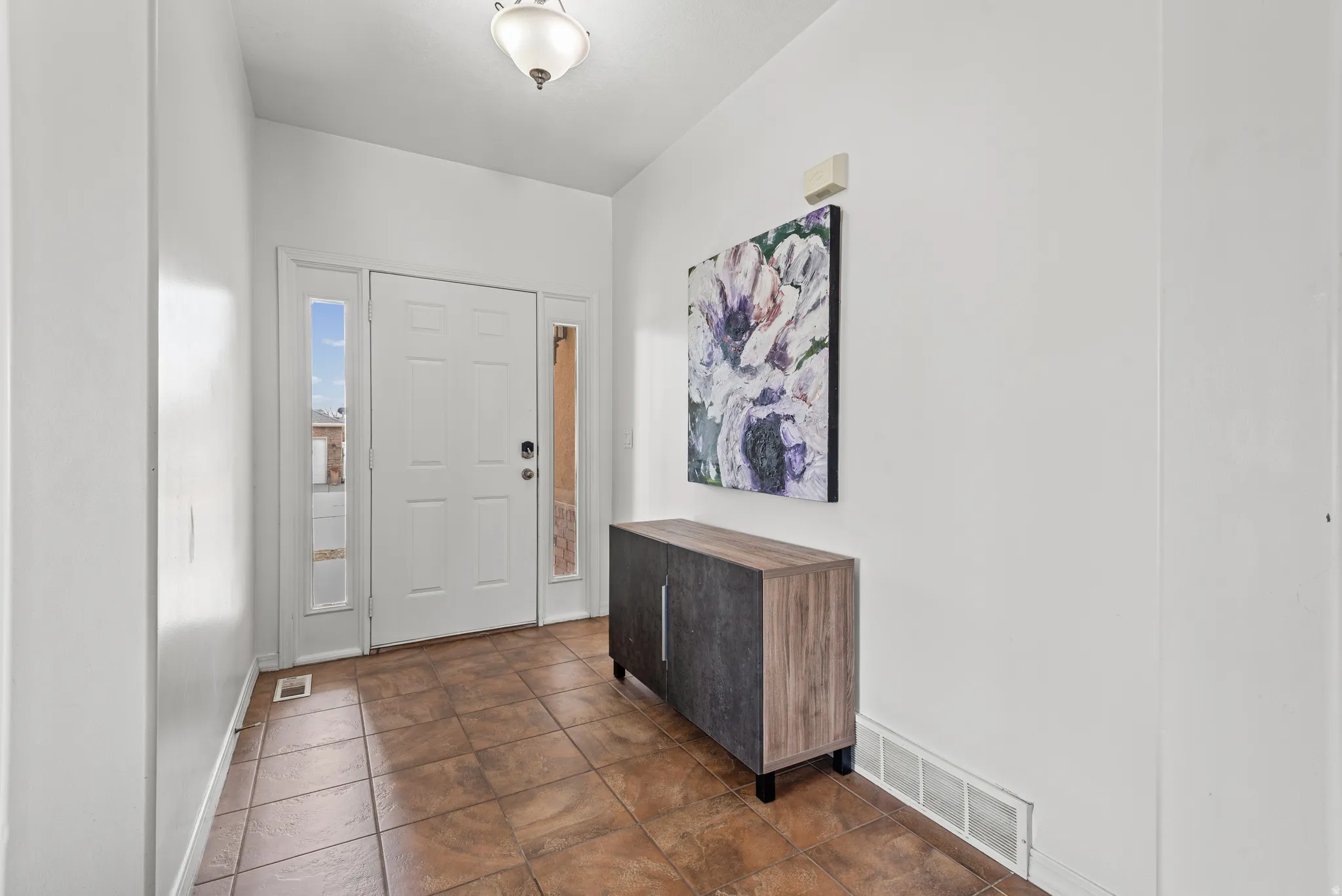 Foyer entrance featuring baseboards