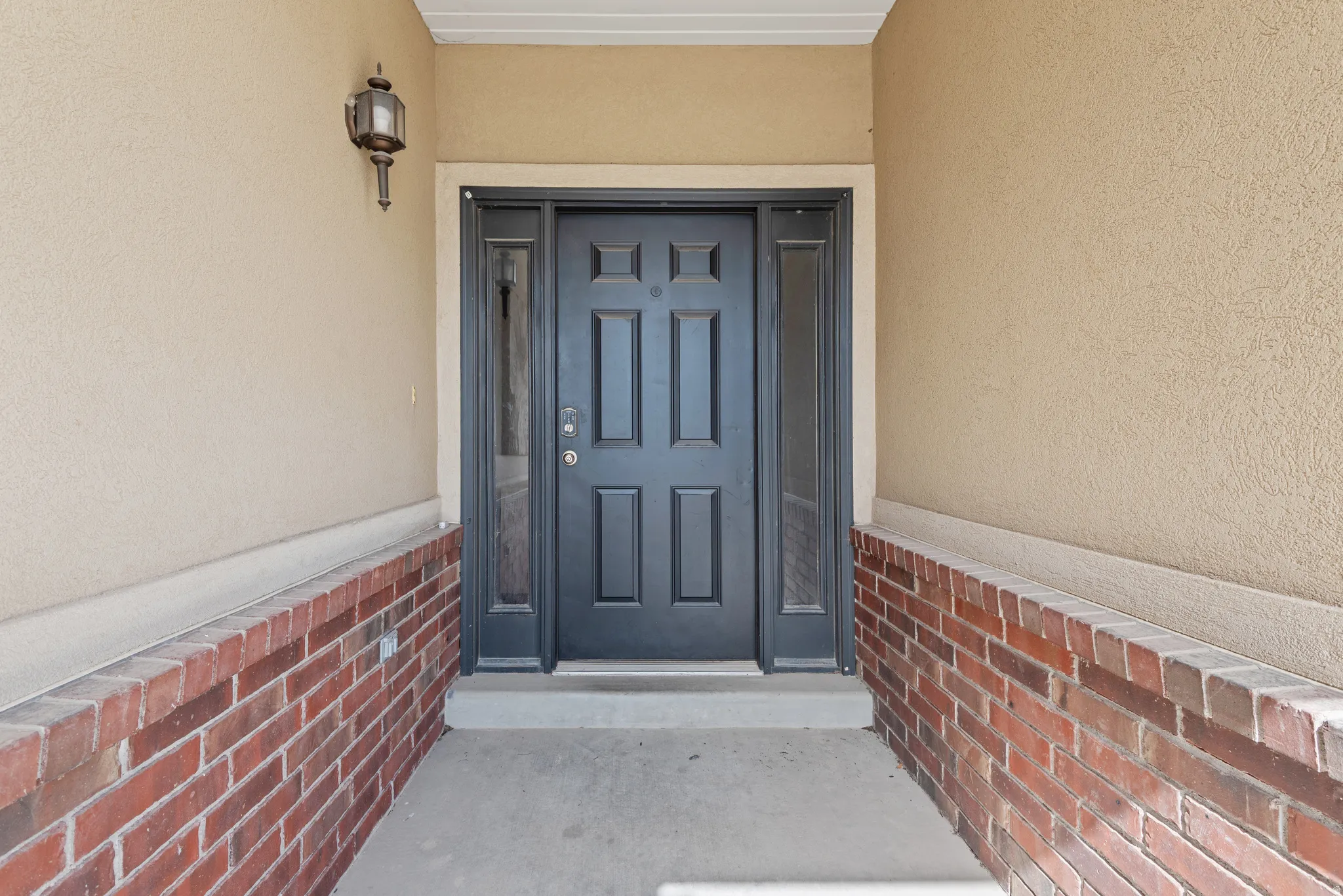 Property entrance featuring stucco siding