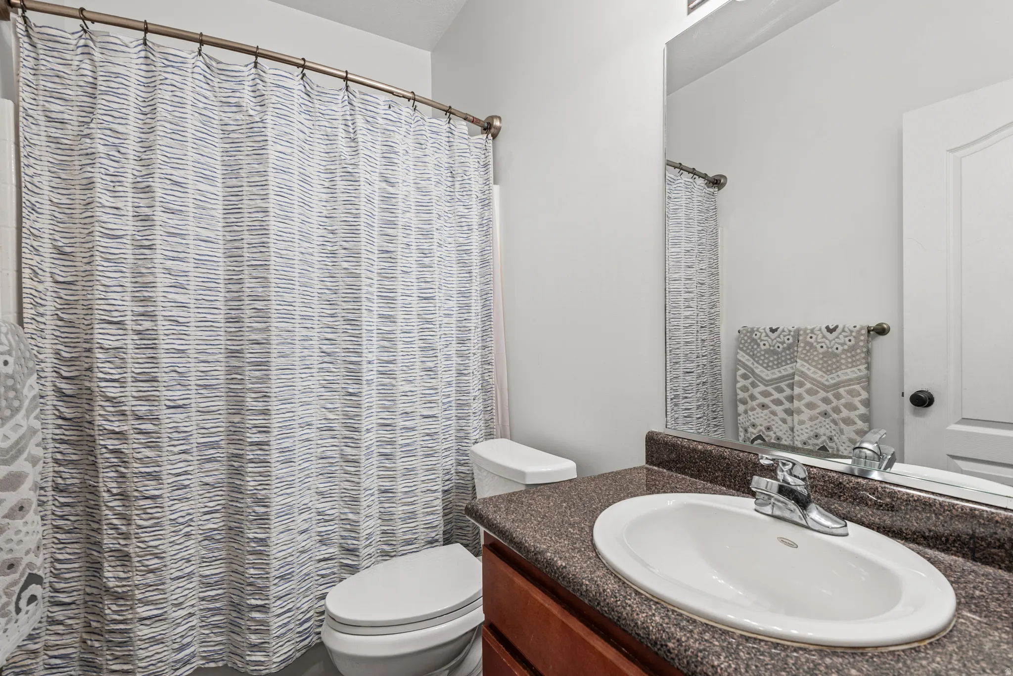 Bathroom with vanity and curtained shower