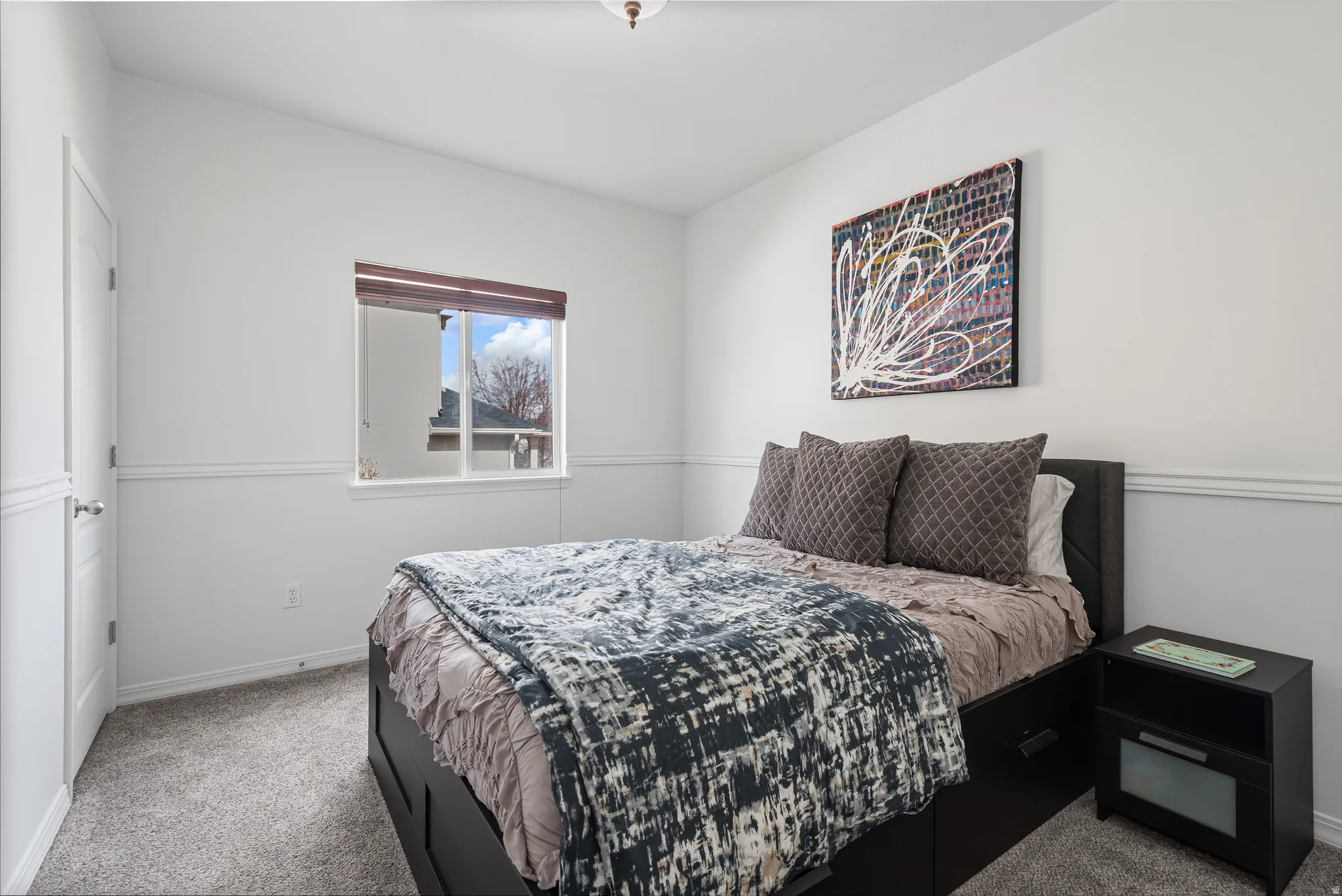 Carpeted bedroom with baseboards