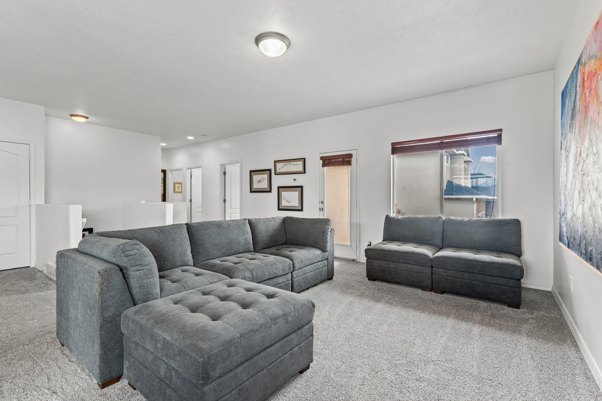 Living room featuring light colored carpet and baseboards