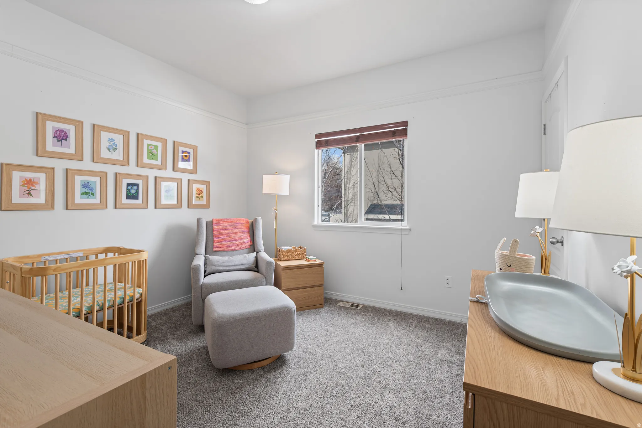 Bedroom with light carpet and a crib