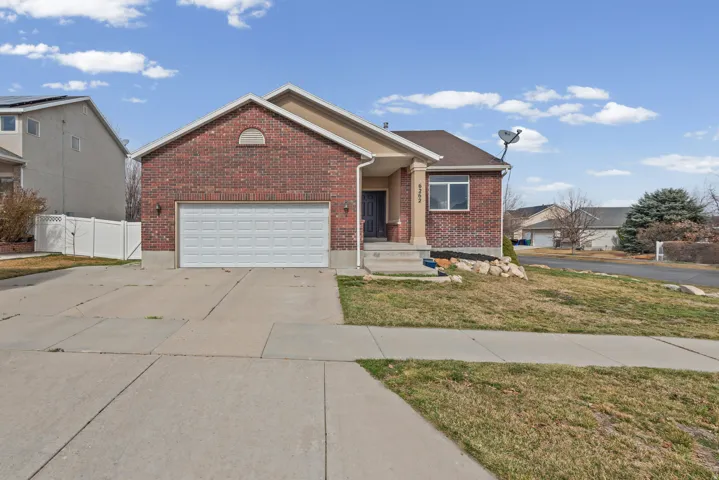 Ranch-style home with brick siding, concrete driveway, and a garage