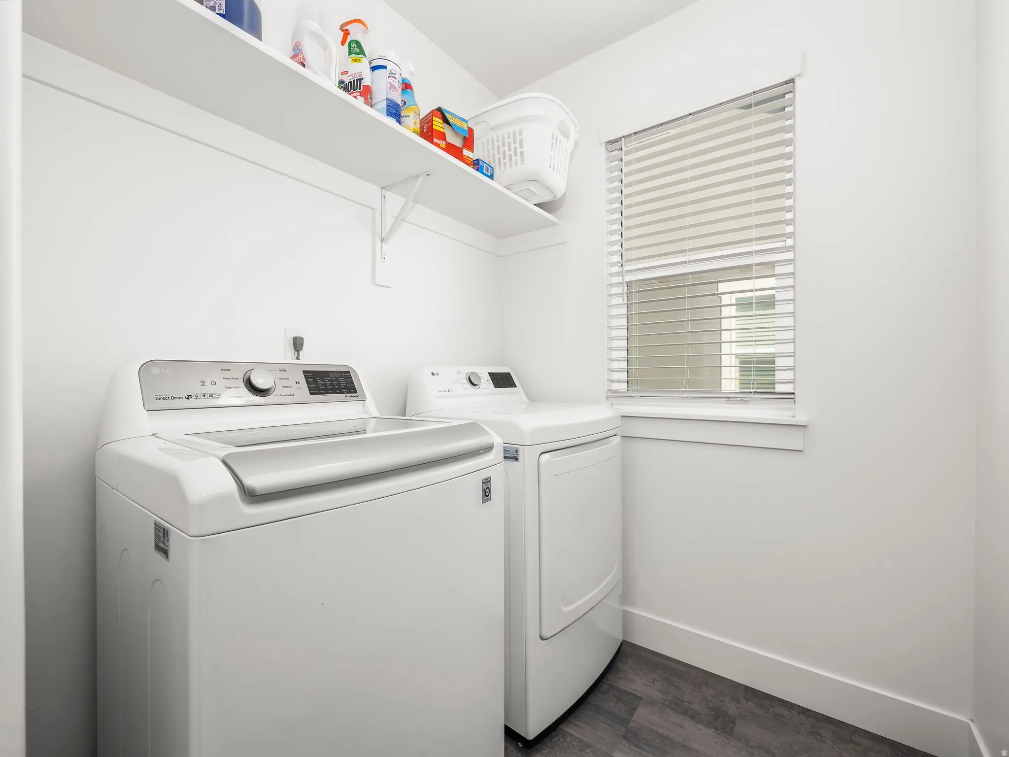 Laundry area featuring dark wood-style floors and washer and clothes dryer