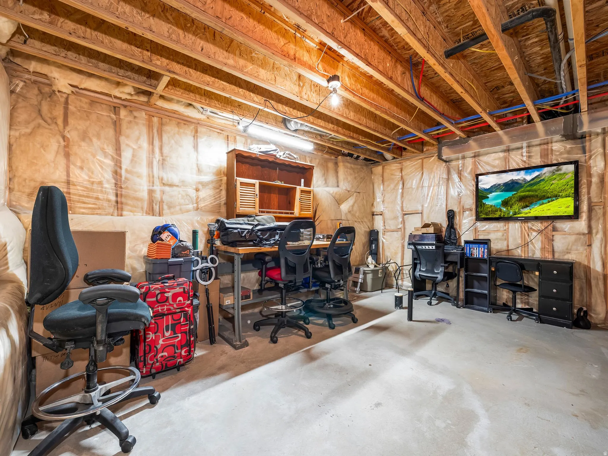 Unfinished below grade area featuring a desk