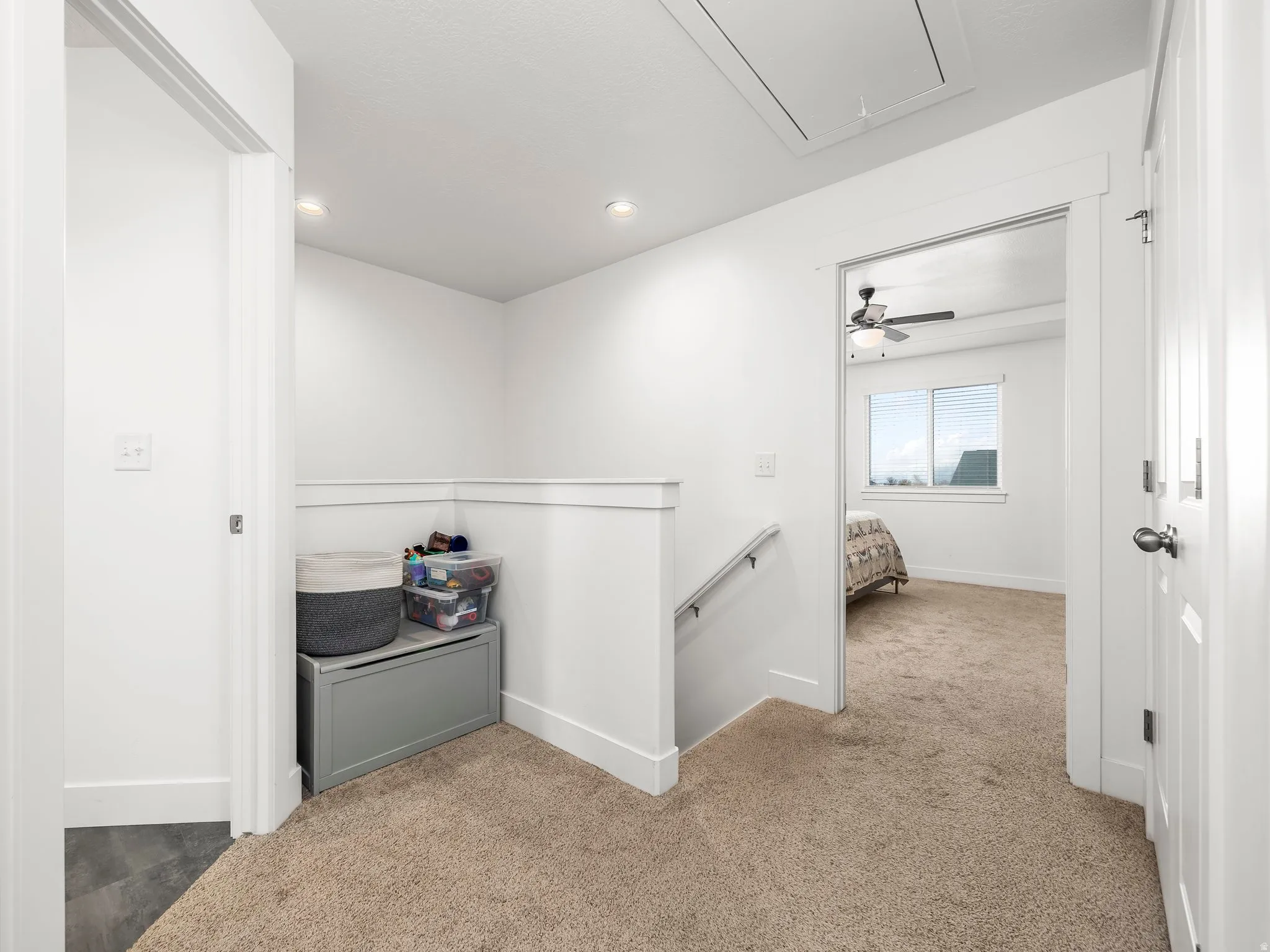 Corridor featuring light colored carpet and recessed lighting