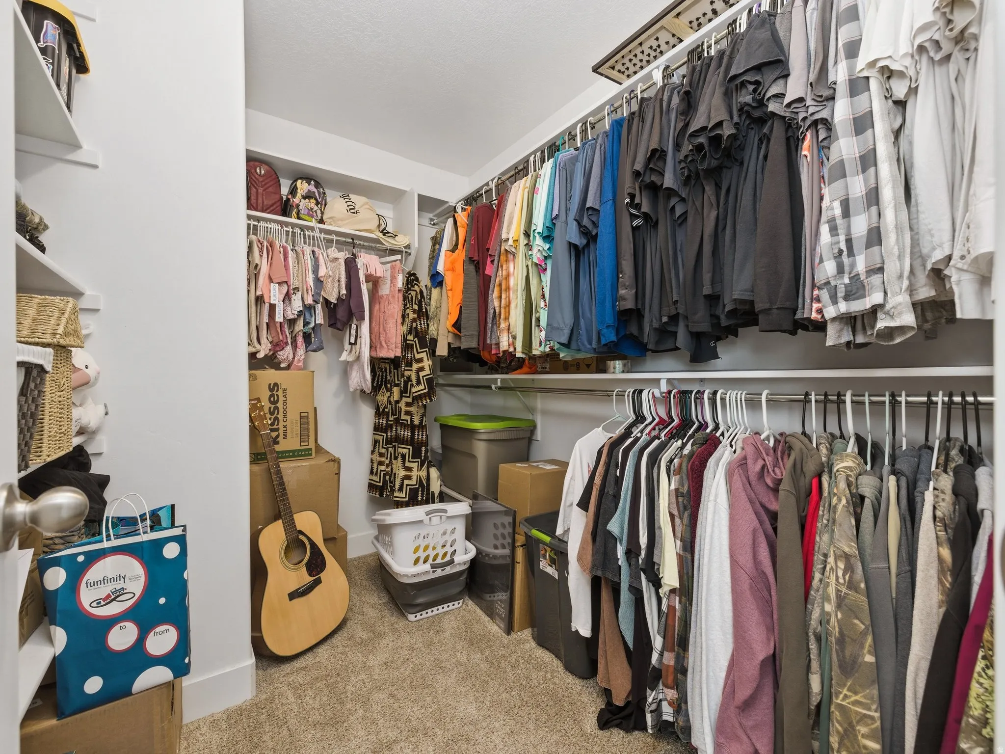 Walk in closet with light carpet