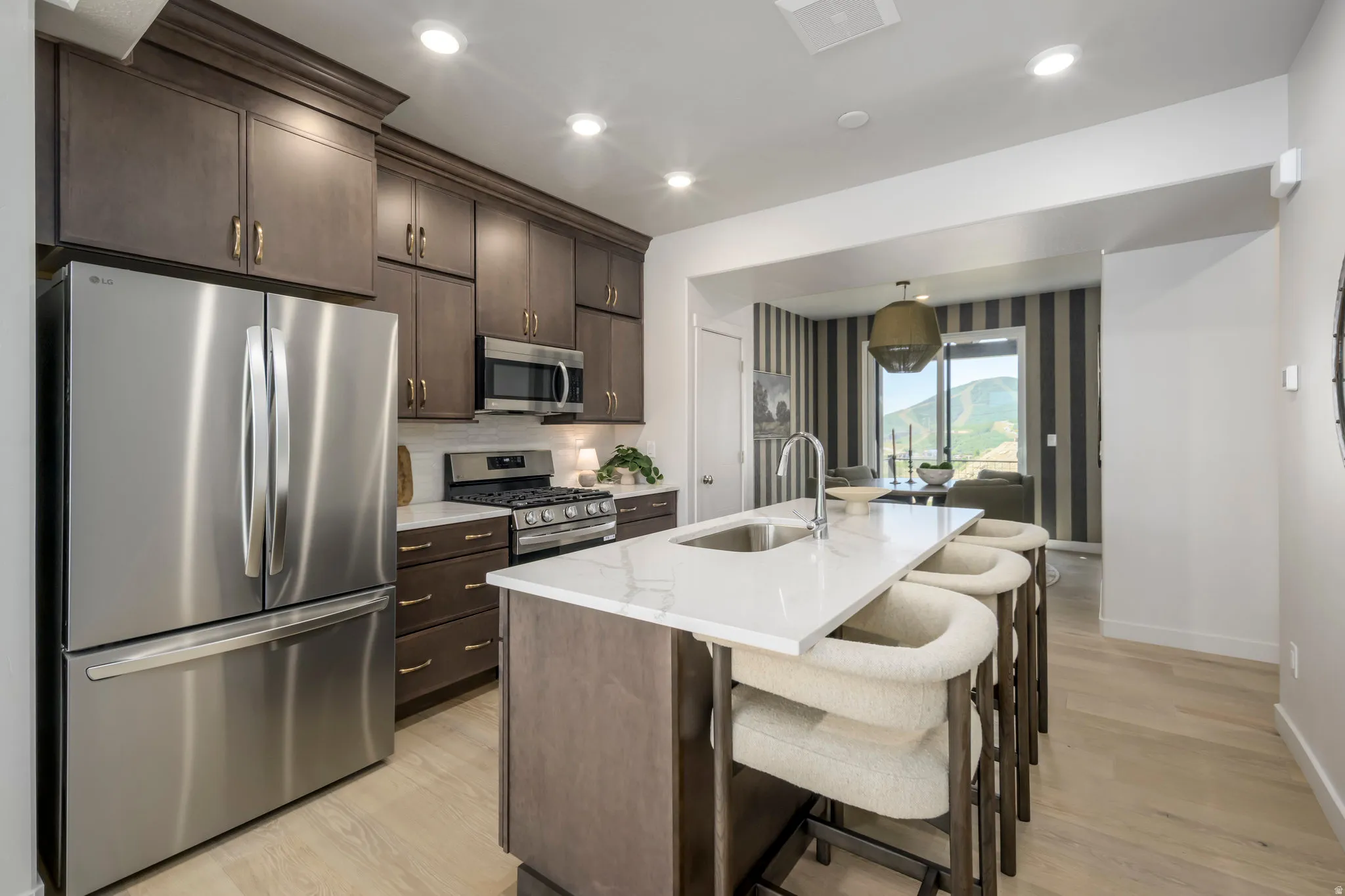 Sleek quartz countertops and modern cabinetry create a stylish yet functional space.