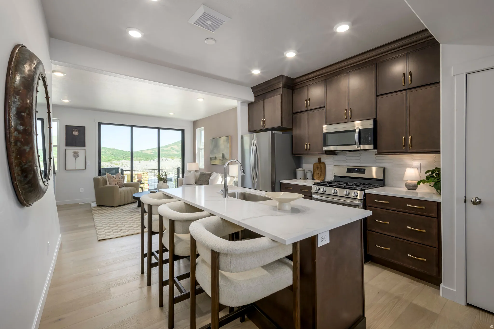 Sleek quartz countertops and modern cabinetry create a stylish yet functional space.