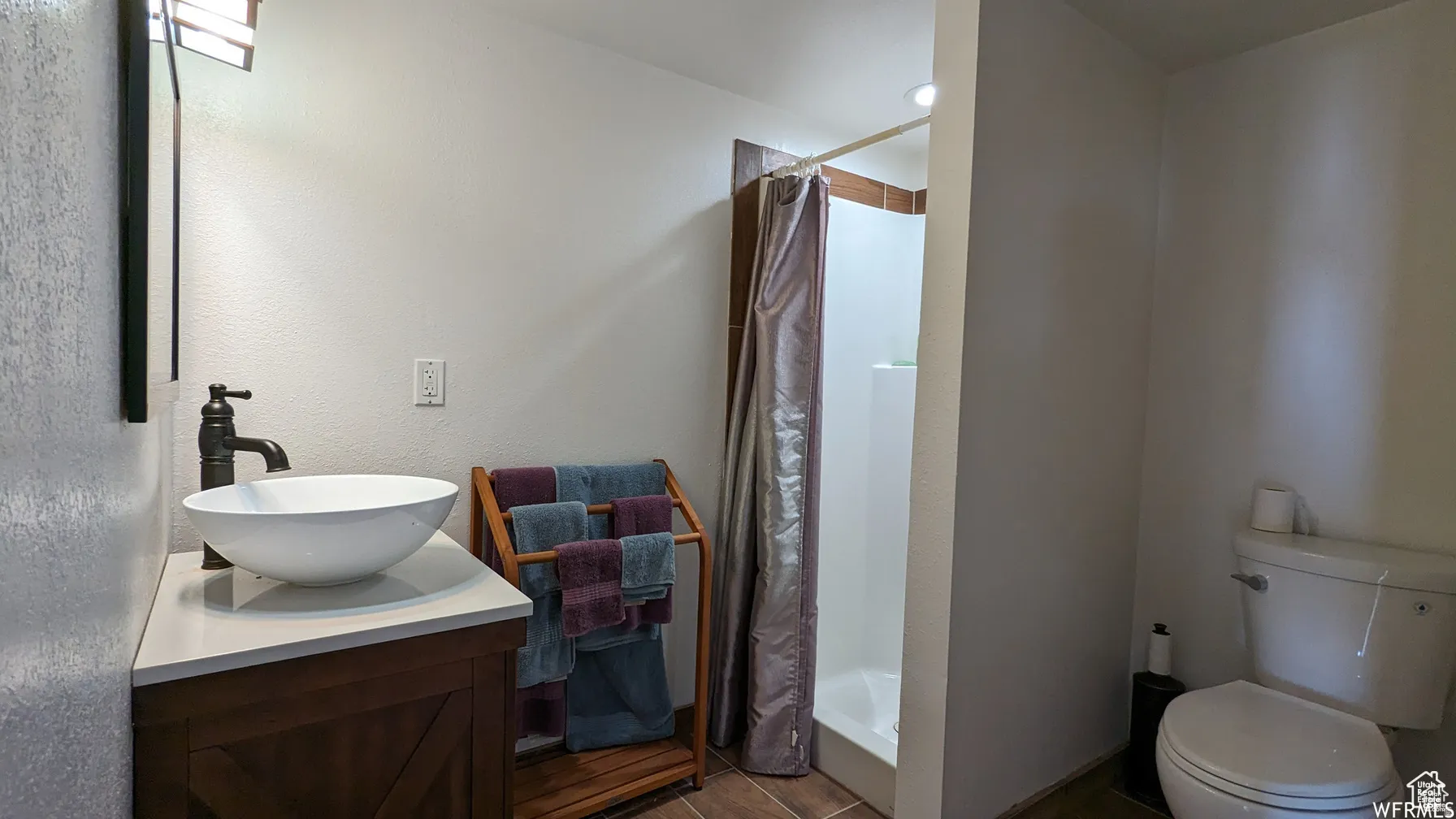 Full bathroom with a stall shower and vanity