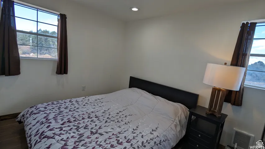 Bedroom with recessed lighting and wood finished floors