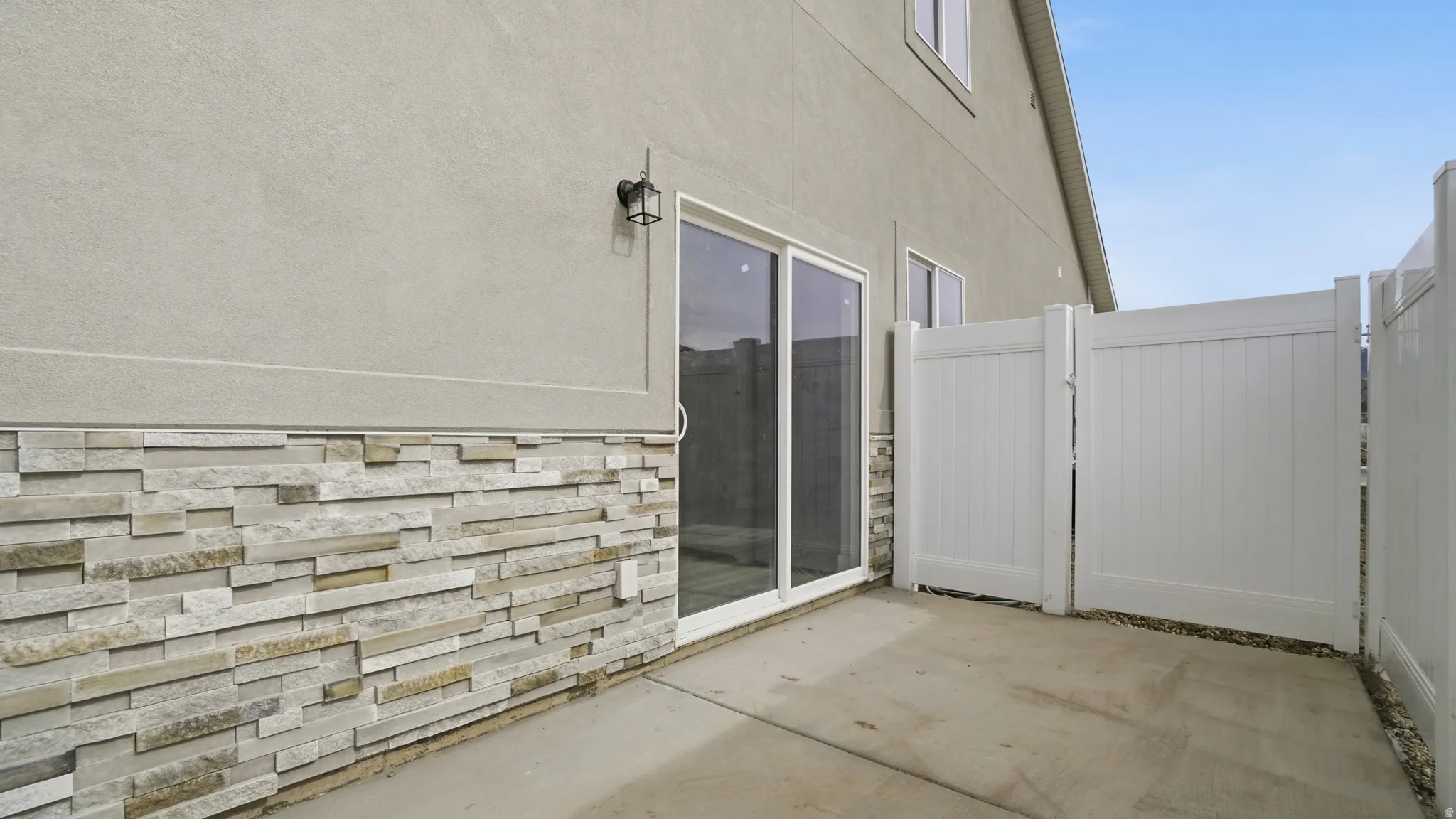 View of patio with a gate