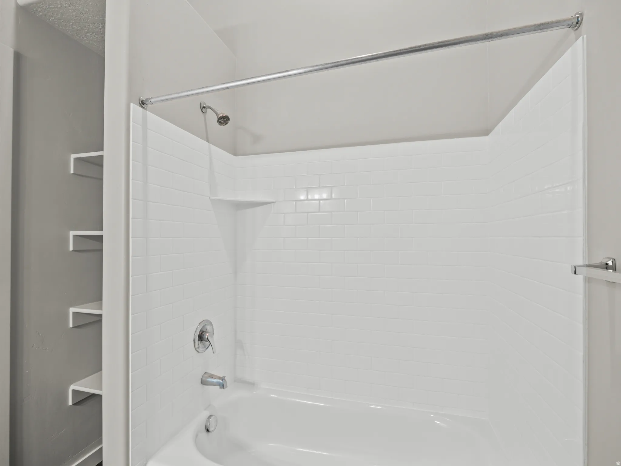 Full bathroom featuring bathing tub / shower combination and a textured ceiling