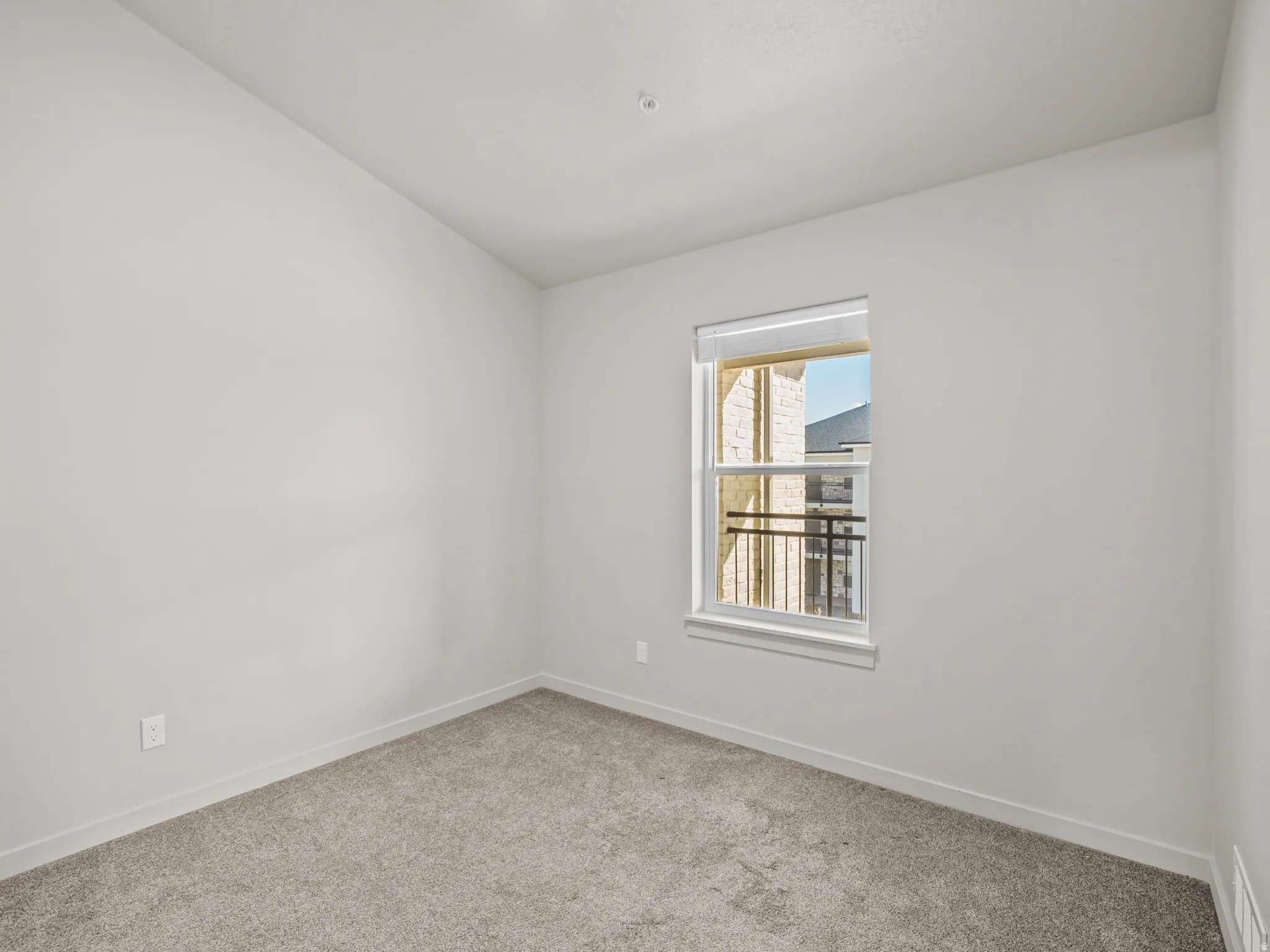 Carpeted spare room with baseboards