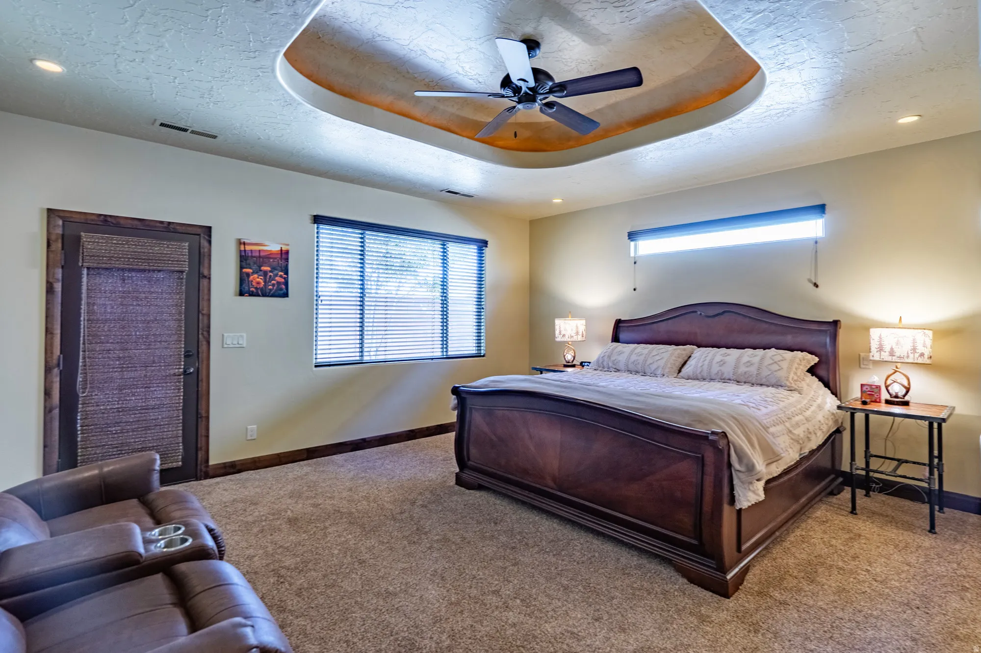 Bedroom featuring a raised ceiling, carpet, a ceiling fan, recessed lighting, and a textured ceiling