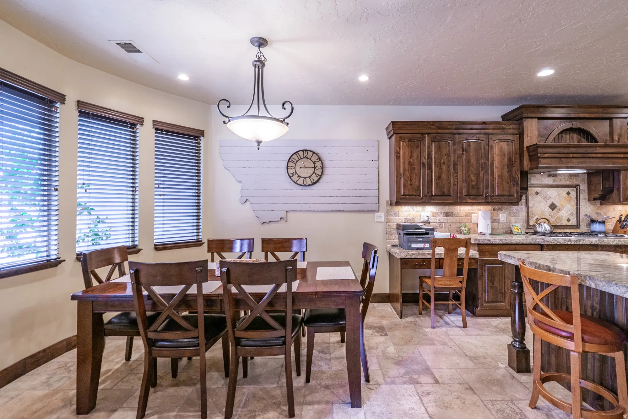 Dining area featuring recessed lighting and stone tile flooring